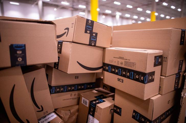 Amazon packages are stacked up at a warehouse in Neubrandenburg, Germany in 2021. The company says a warehouse worker's death in Carteret, New Jersey in July 2022 wasn't work related, but some employees and labor leaders are questioning that.